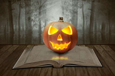 Jack-o-lantern and book on a wooden table with a lake in the forest with a dramatic scene background. Halloween concept