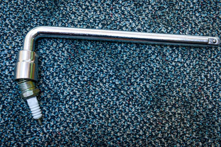 Spark plug with wrench handle on the carpetの写真素材