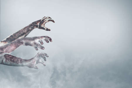 Zombie hand with blood and wound in the fogの写真素材