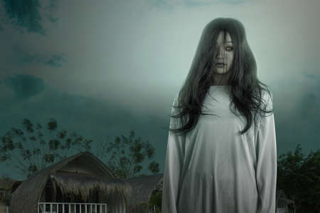 Scary ghost woman standing with night scene background. Halloween concept