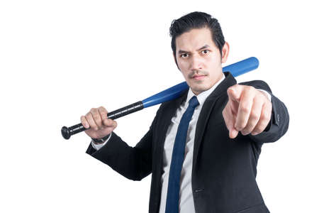 Asian businessman holding a baseball bat isolated over white backgroundの写真素材