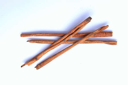 Cinnamon sticks isolated over white backgroundの写真素材