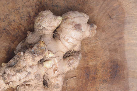 Fresh ginger on wooden background