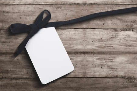 White label tag with black ribbon on wooden background. Cyber Monday conceptの写真素材