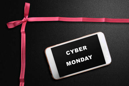 Cyber Monday text on the mobile phone screen with a black background. Cyber Monday conceptの写真素材
