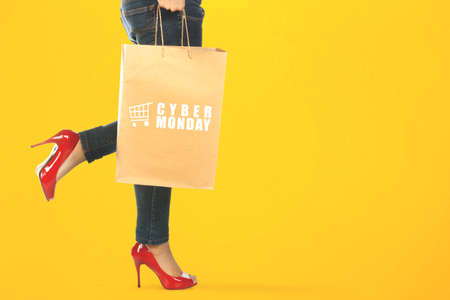A woman carrying a shopping bag with Cyber Monday text. Cyber Monday concept