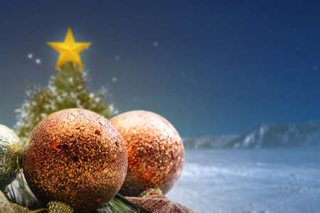 Colorful Christmas ornament on a wooden table with a Christmas tree with a snowy background. Merry Christmasの写真素材