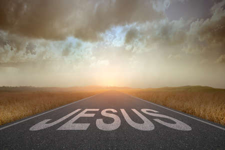 Jesus text on the street with a sunset sky background