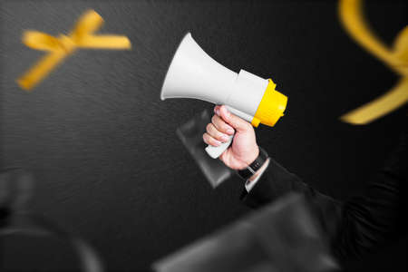 Businessman holding megaphone to announce of Black Friday promotion on a black background. Black...