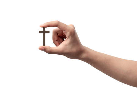 Human hand holding Christian cross isolated over white backgroundの写真素材