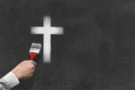 Businessman hand painted Christian cross on the wallの写真素材