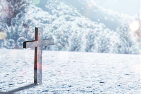 Christian cross on the snow with snowfall backgroundの写真素材