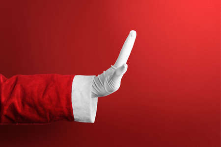 Santa Claus with a hand gesture with a red background. Merry Christmas