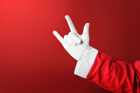 Santa Claus with a hand gesture with a colored background. Merry Christmas
