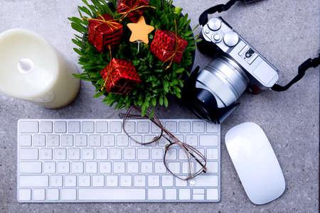 Close up view of millet grass plant in the pot with christmas decoration and the keyboard on the...
