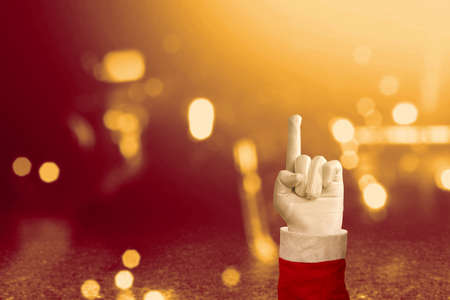 Santa Claus hand pointing something with blurred light background. Empty space for copy spaceの写真素材