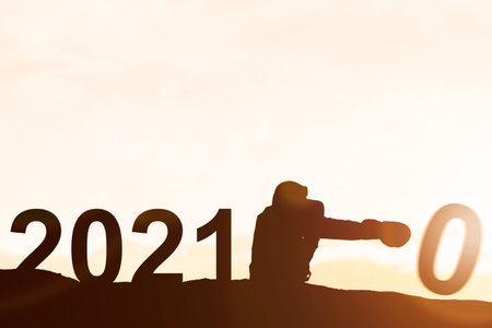 Silhouette of businessman changing 2020 to 2021. Happy New Year 2021の写真素材