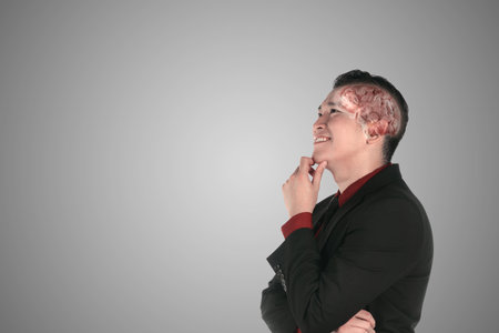 Asian businessman with a cog brain thinking something with a gray background
