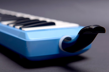 Pianica blow-organ musical instrument with black backgroundの写真素材