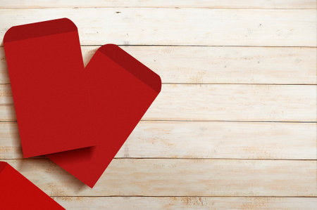 Stack of red envelopes (Angpao) with wooden backgroundの写真素材
