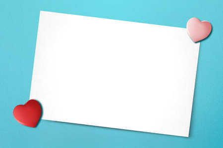 Empty white paper and heart with a colored background. Valentines Day. Empty space for copy space
