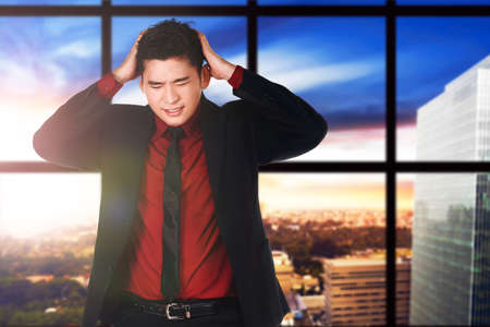 Asian businessman feeling depressed in the workplaceの写真素材