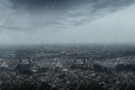 View of urban life with rain and dark cloud background