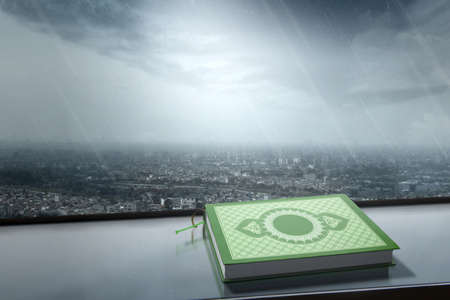 Quran besides the window with cityscapes and rain backgroundの写真素材
