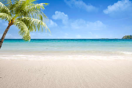 Sandy beach with the blue ocean and blue sky backgroundの写真素材