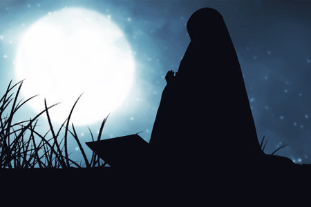 Silhouette of Muslim woman in a veil sitting and praying with the night scene backgroundの写真素材