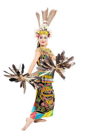Asian woman dancing East Kalimantan traditional dance (Giring-Giring dance) isolated over white backgroundの写真素材