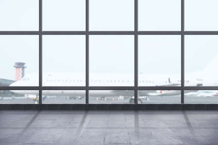 Airport terminal view with the plane on the runwayの写真素材