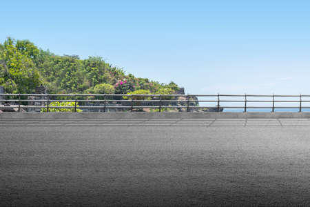 Asphalt road with cliff view and blue sky background