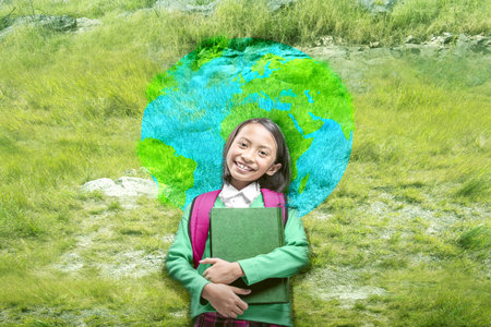 Asian little girl with book and backpack standing with the earth pattern background. World Children...