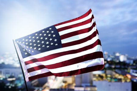 American flag waving in the air with a sky background. Fourth of July Conceptの写真素材