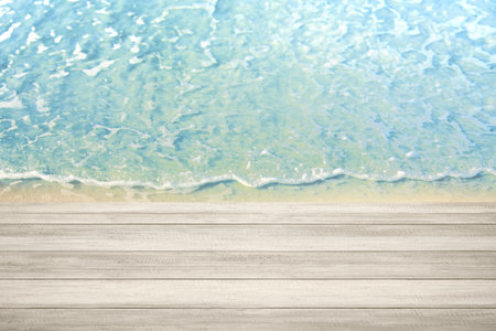 Wooden table with water waves on the beach