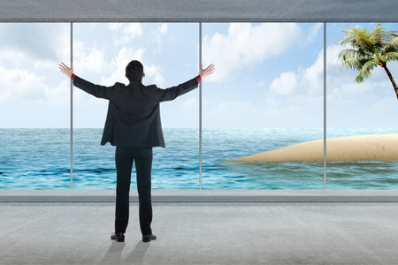 Rear view of Asian businessman enjoying a vacation with ocean view from the hotelの写真素材