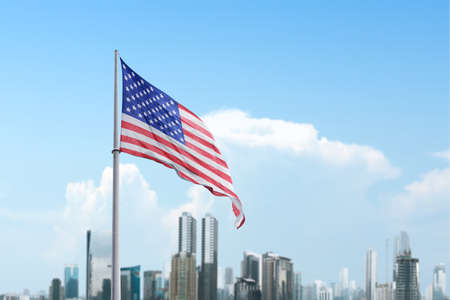 American flag waving in the air with a blue sky background. Fourth of July Conceptの写真素材