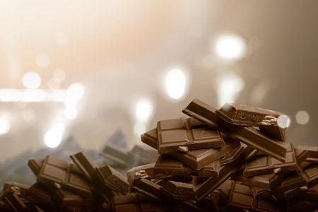 Piece of chocolate with blurred light backgroundの写真素材