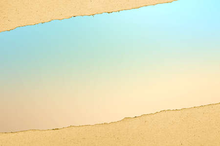 Paper with a hole torn with colored backgroundの写真素材