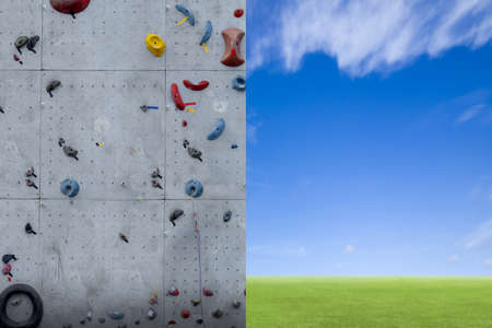 Rock climbing on an artificial wall with blue sky backgroundの写真素材