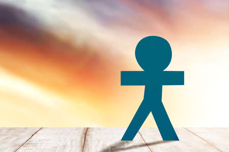 Blue people paper standing with a dramatic sky background. World Population Day concept