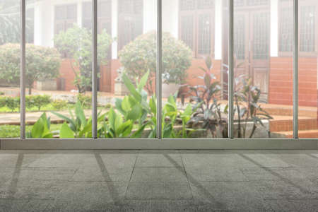 Empty room with window glass and garden view backgroundの写真素材
