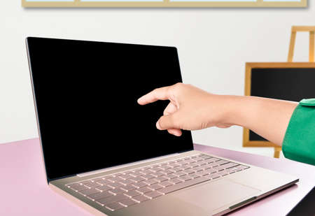 College student pointing laptop screen at home. Back to School concept