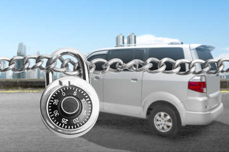 Chain of metal steel with padlock and car on the streetの写真素材