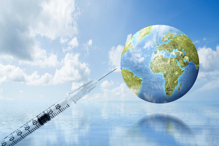 The syringe of covid 19 vaccination for the worldの写真素材