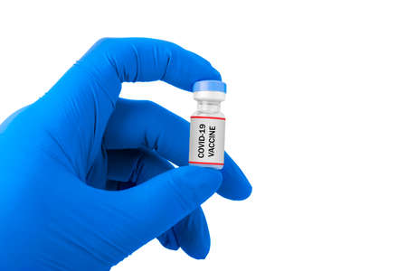 Health worker hand with gloves holding covid 19 vaccines isolated over white backgroundの写真素材