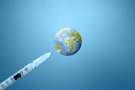 The syringe of covid 19 vaccination for the worldの写真素材