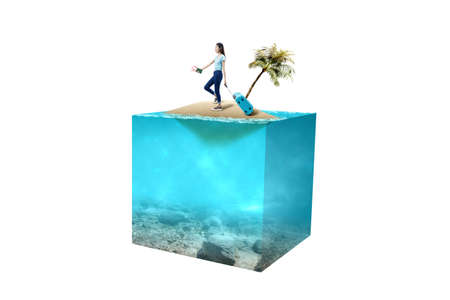 Asian woman with a suitcase holding ticket and passport on a little island with an underwater view...