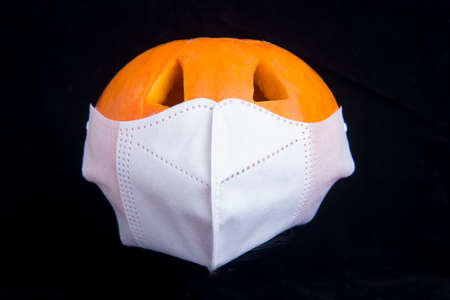 Jack-o-Lantern in the face mask with a black backgroundの写真素材